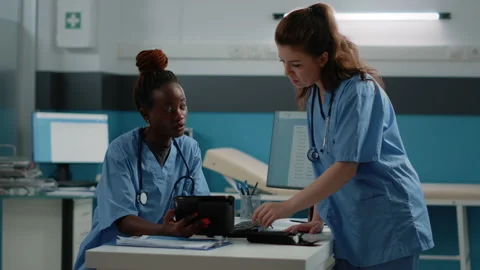 Medical team of nurses using tablet with touch screen Video stock 163436562