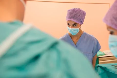Medical team performing an operation in an operating room Stock Photos