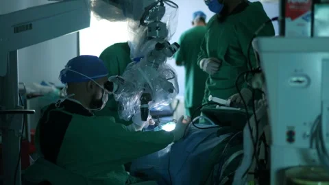 Medical Team Performing Surgery in Fully Equipped Hospital Operating Room Stock Footage 308495723