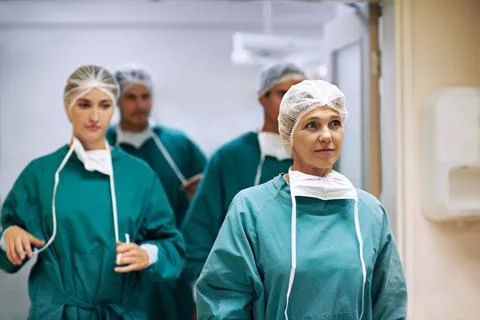 Medical, teamwork and walking with doctors in hospital together for operation or Stock Photos