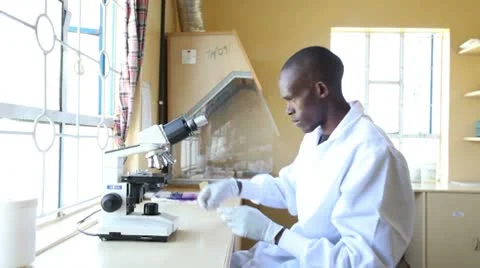 Medical technician using microscope in clinic. Kenya, Africa. Stock-Footage 8976519