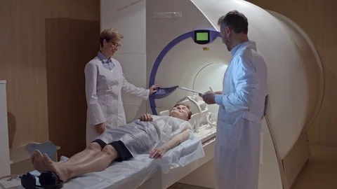 Medical Technicians Preparing Patient for MRI Scan Stock Footage