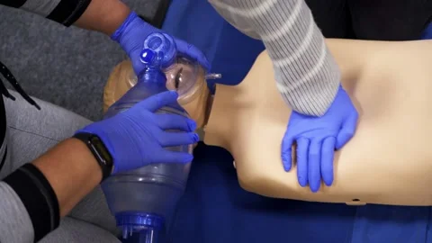 Medical training session. Practitioners doing a compression of heart attack Stock Footage 145330358
