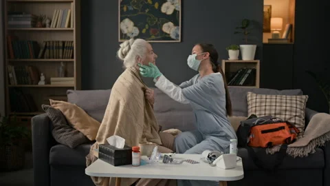 Medical Worker Checking Lymph Nodes in Elderly Womans Neck Visiting Her at Home Stock Footage 329171421