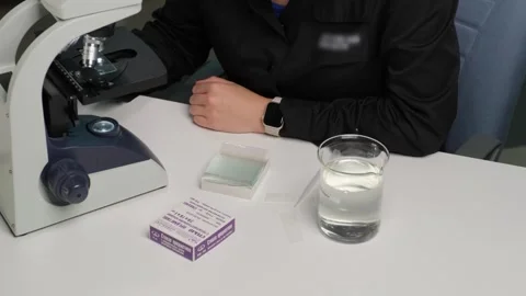 Medical Worker Conducting Microscope Analysis in Laboratory Stock Footage 306326959