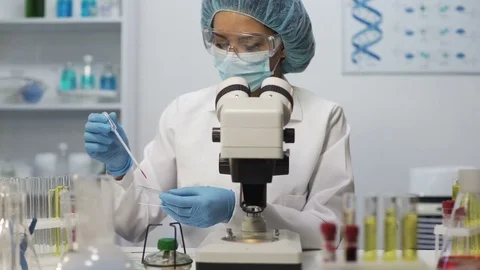 Medical worker doing blood analysis on microscope at laboratory, health-care 库存影片 73707874