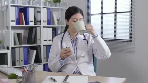 Medical worker drinking tea at her seat Stock Footage 148771345