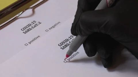 Medical worker marking checkbox COVID-19 test as positive Stock Footage 132364134