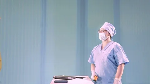 A medical worker measures the temperature remotely for employees before the Stock Footage 127295771
