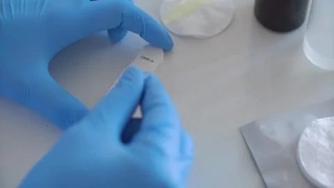 Medical worker performs rapid covid test with liquid drops Video stock 333830663