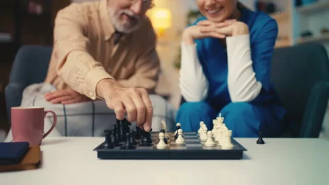 Medical worker playing chess with elderly man in retirement home, brain exercise Stock Footage 279177341