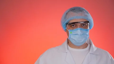 Medical worker taking off protective glasses, mask and hat. Stock Footage 129706602