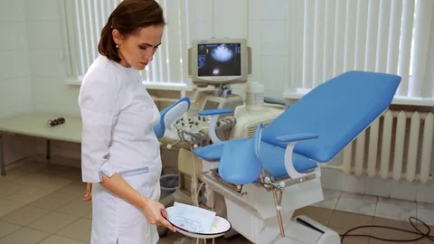 The medical worker throws used tools into the bin. A gynecologist throws Stock Footage 119302656