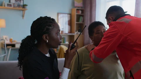 Medical Worker Using Radio while Paramedic Evaluating Health Condition of Woman Video stock 318899111