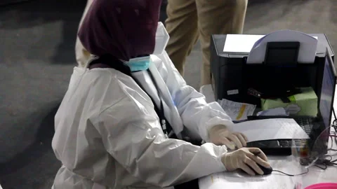 Medical workers check the data and medical history of people who have recently r Stock Footage 149286710