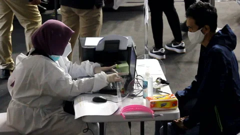 Medical workers check the data and medical history of people who have recently r Stock Footage 149286802