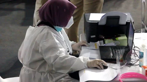 Medical workers check the data and medical history of people who have recently r Stock Footage 149286968