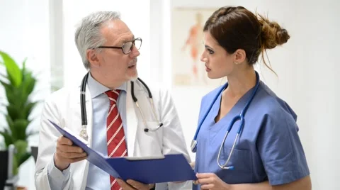 Medical workers reading a document Stock Footage 68769223