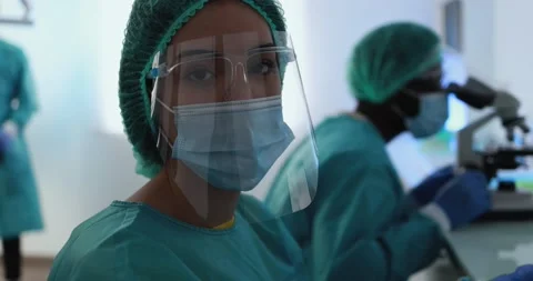 Medical workers working with laptop computer and micoroscope Stock Footage 149116641