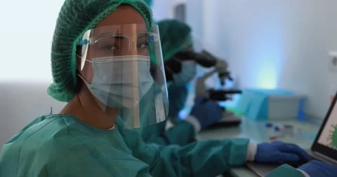 Medical workers working with micoroscope inside laboratory Stock Footage 149116664