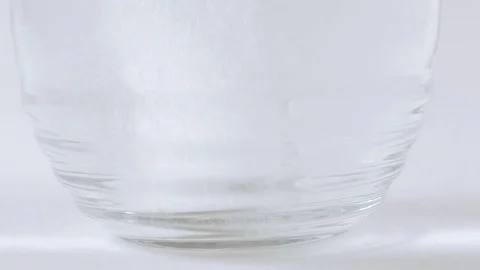 Medicated Effervescent Tablet Drops into Water Glass Stock Footage 74606655