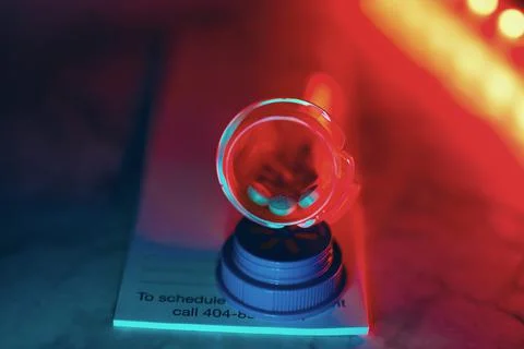 Medication bottle with pills neon glow Stock Photos