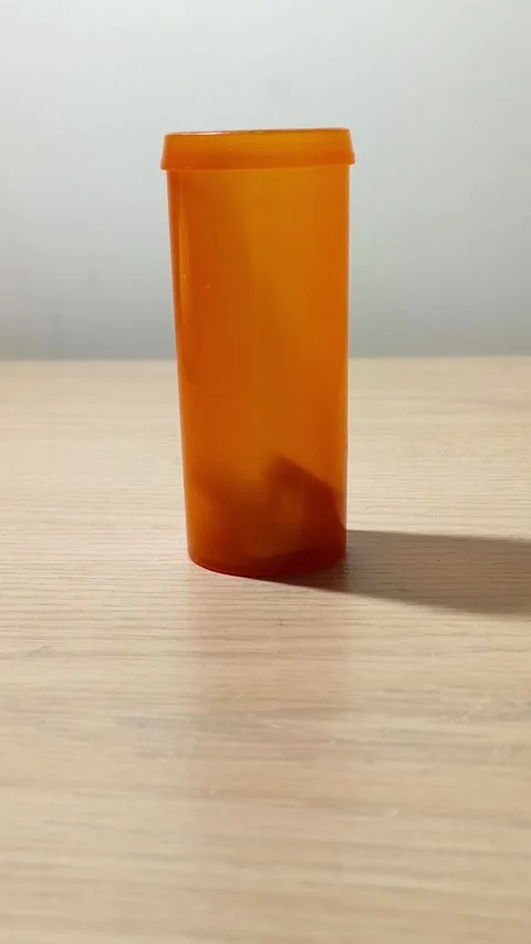 Medication bottle spinning on a wooden table highlighting prescription Video stock 318311053