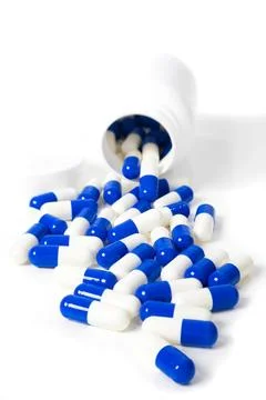 Medication - Capsules spilling out of bottle Foto stock