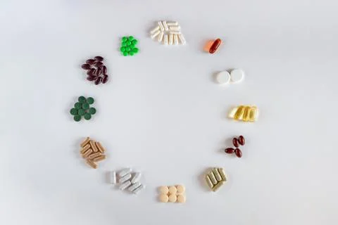 Medication with different types and colours as clock face on white background Stock Photos