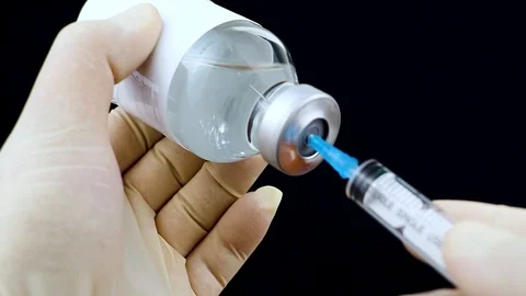 Medication drug needle syringe drug,medical concept flu shot vaccine vial dose h Stock Footage