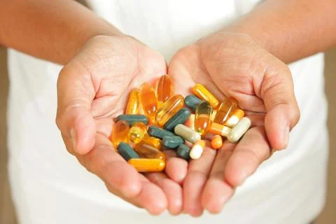Medication in the hands of the elderly. Stock Photos