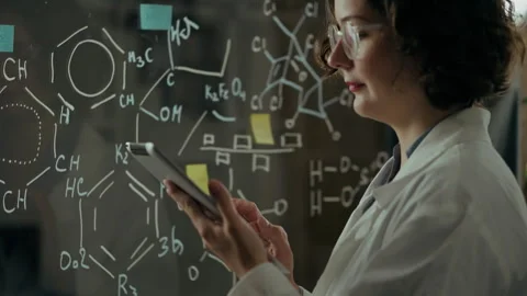 Medication, microbiology doctor keeps looking into the screen of the tablet Stock Footage 245430431