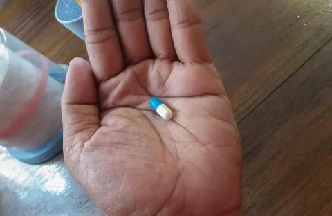 Medication in patient's hands Stock Photos