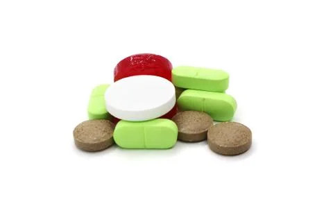 Medication pills are a bunch of multi-colored objects isolated on a white bac Foto stock