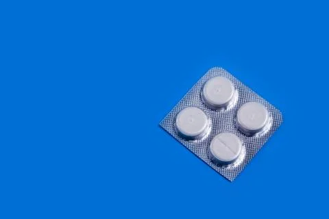 Medication pills on a plain background. copy space one Stock Photos