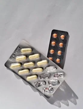 Medication Tablets in Blister Packaging on White Stock Photos