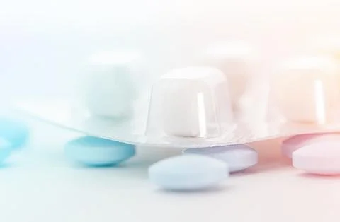 Medications closeup, matrix of tablets. Pharmaceutical concept. Stock Photos