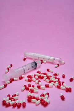 Medications on a pink table. Stock Photos
