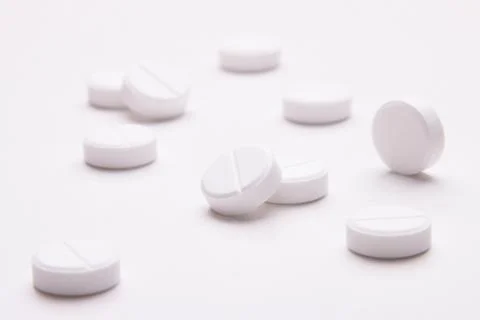 Medications scattered on a white table Stock Photos