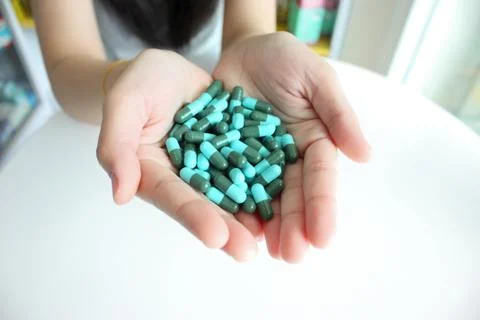 Medicinal capsule on hand. Stock Photos