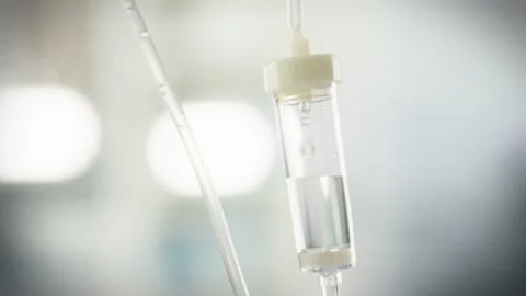 A medicinal liquid flows steadily through a transfusion system into an intra Stock Footage 331314739