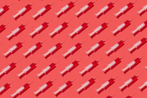 Medicinal pattern from syringes with red liquid or serum. Stock Photos