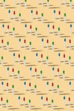 Medicinal pattern from vertically standing disposable syrenges. Stock Photos