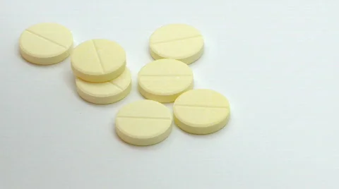 Medicinal pills falling on the table Stock Footage 595817
