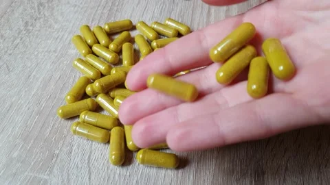 Medicinal pills falling on the table Video stock 130511123