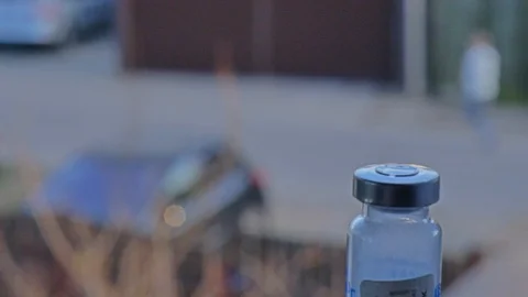 A medicine bottle in the foreground. View from the window to the street. Stock Footage 127175746