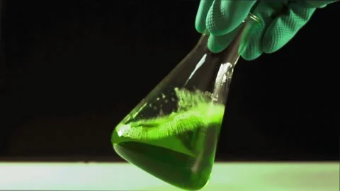 Medicine Bottle With Green Solution In A Laboratory In Hand Of Experimenter Stock-Footage 133373128