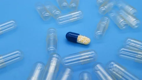 Medicine capsule in the middle of empty capsules Stock Footage 167460928