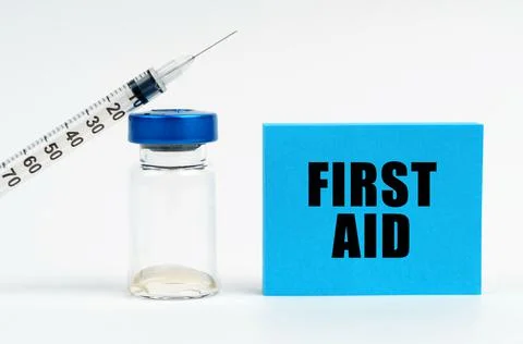 Medicine concept. On the table is a syringe, an injection and a blue sign wit Stock Photos