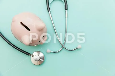 Medicine doctor equipment stethoscope or phonendoscope and piggy bank isolate Stock Photos